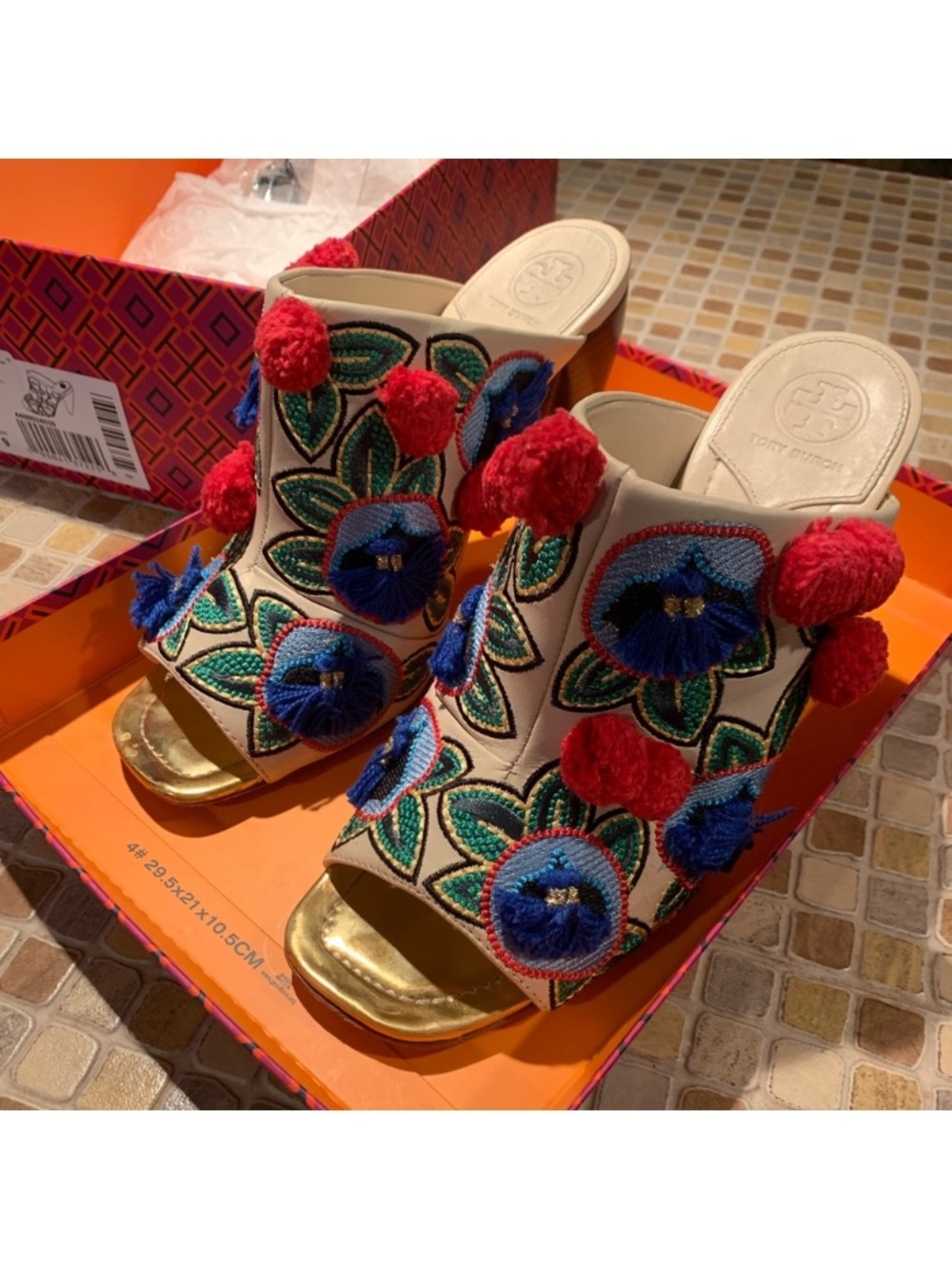 Tory Burch Cream Slide Mules with Blue Floral Embroidery and Red Pom-Poms
